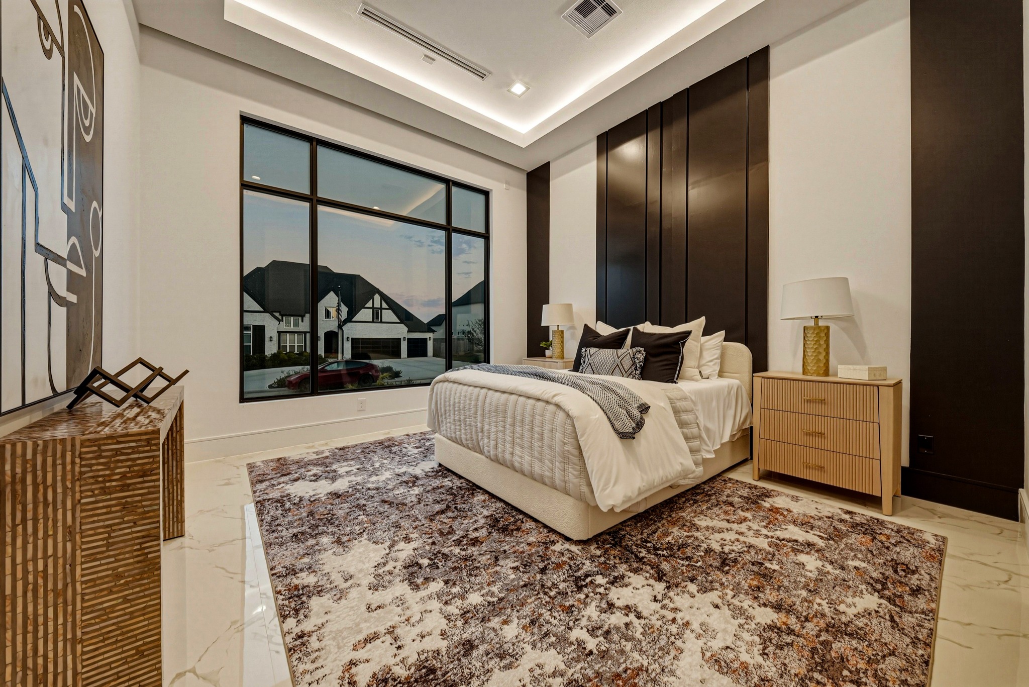 Contemporary bedroom with dark cabinetry and a wide window