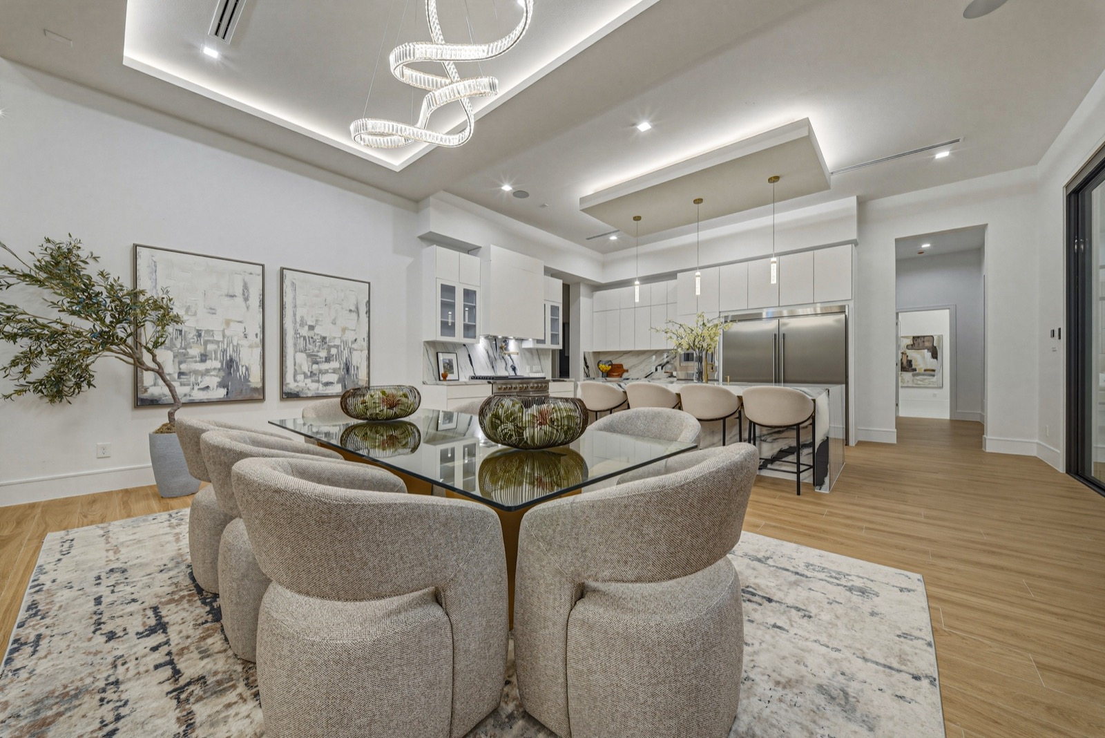 Light-filled dining room with a round table and modern pendant