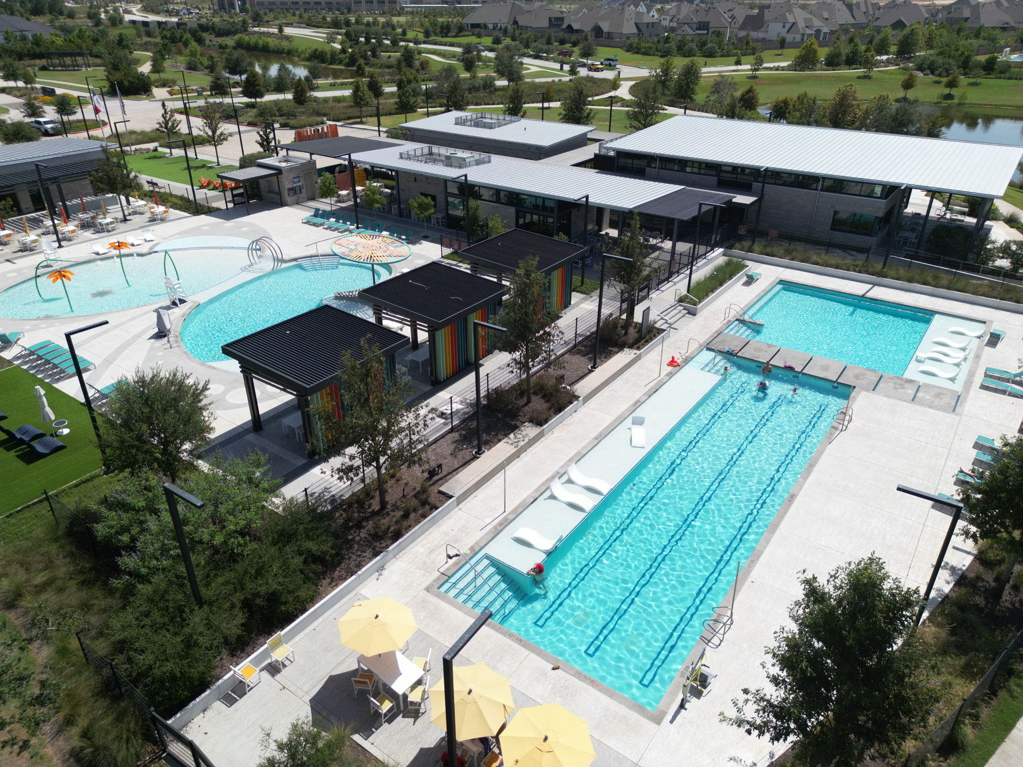 Elevated view of a lap pool, resort pools, and recreation buildings