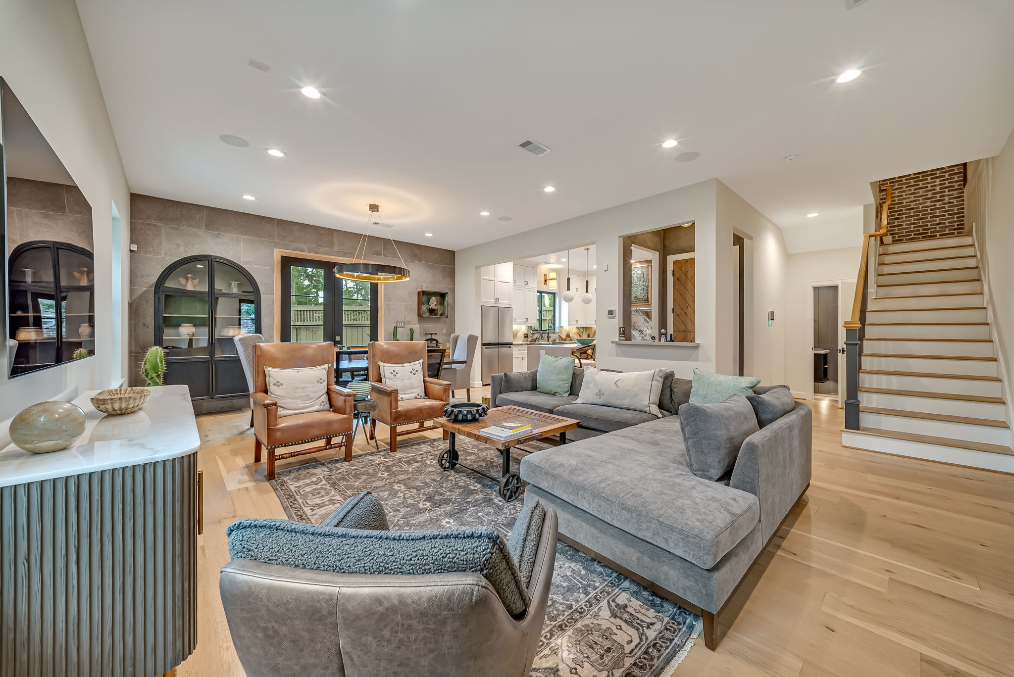 Open living area with seating, arched openings, and a staircase