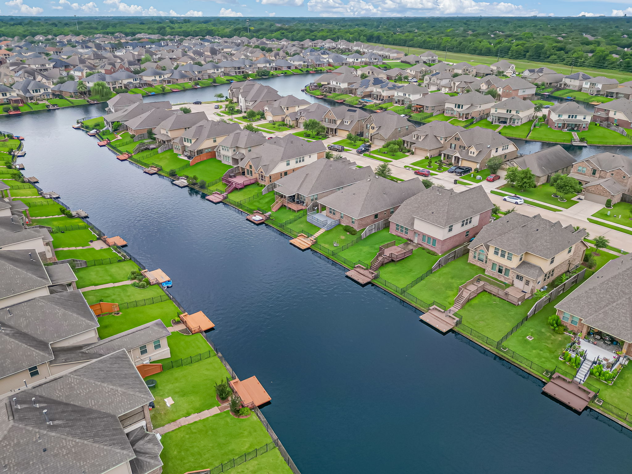Aerial view of a waterway lined with neighborhood homes