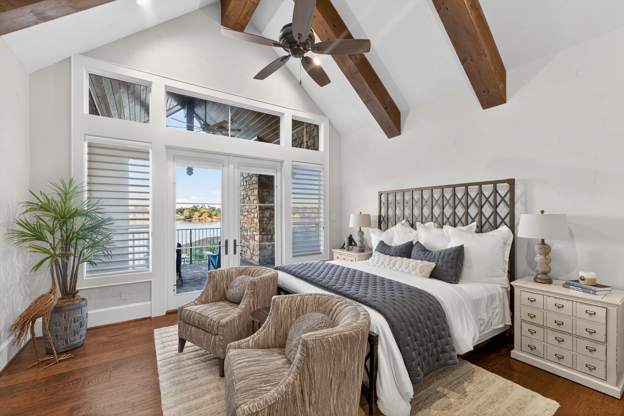 Bright bedroom with exposed beams and tall windows