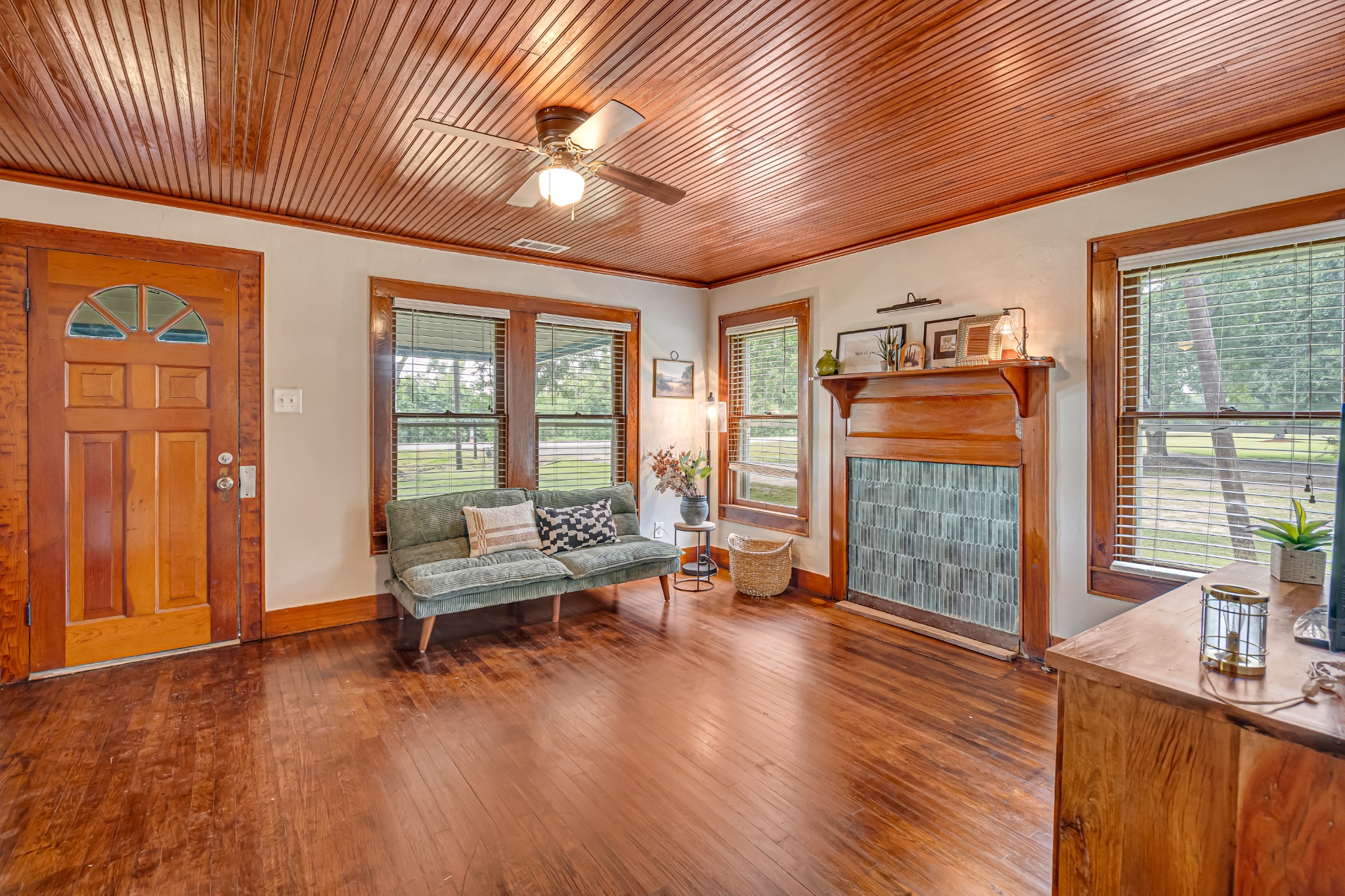 Living room with a wood ceiling, fireplace, and seating by the window