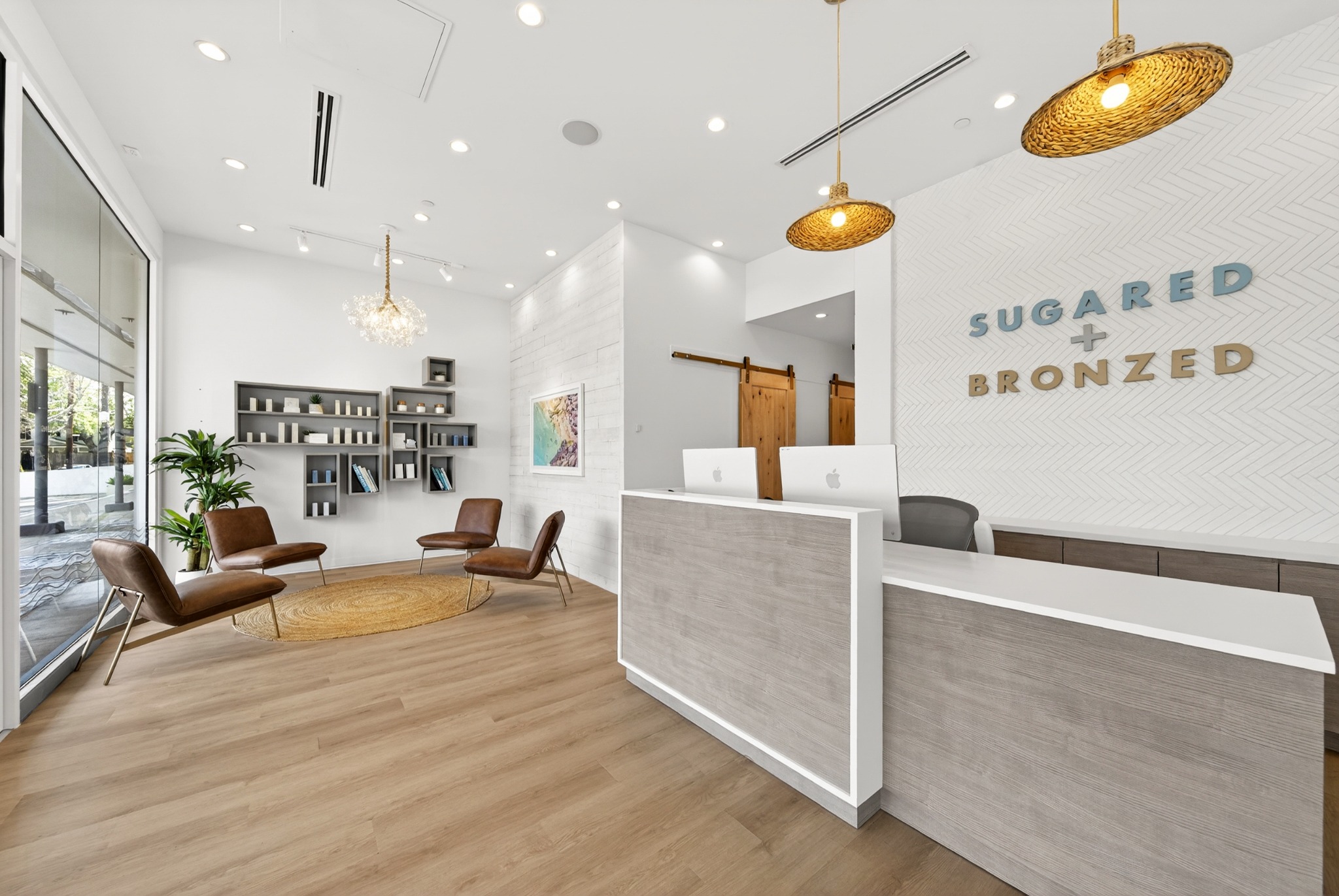 Bright reception area with branded wall and pendant lighting
