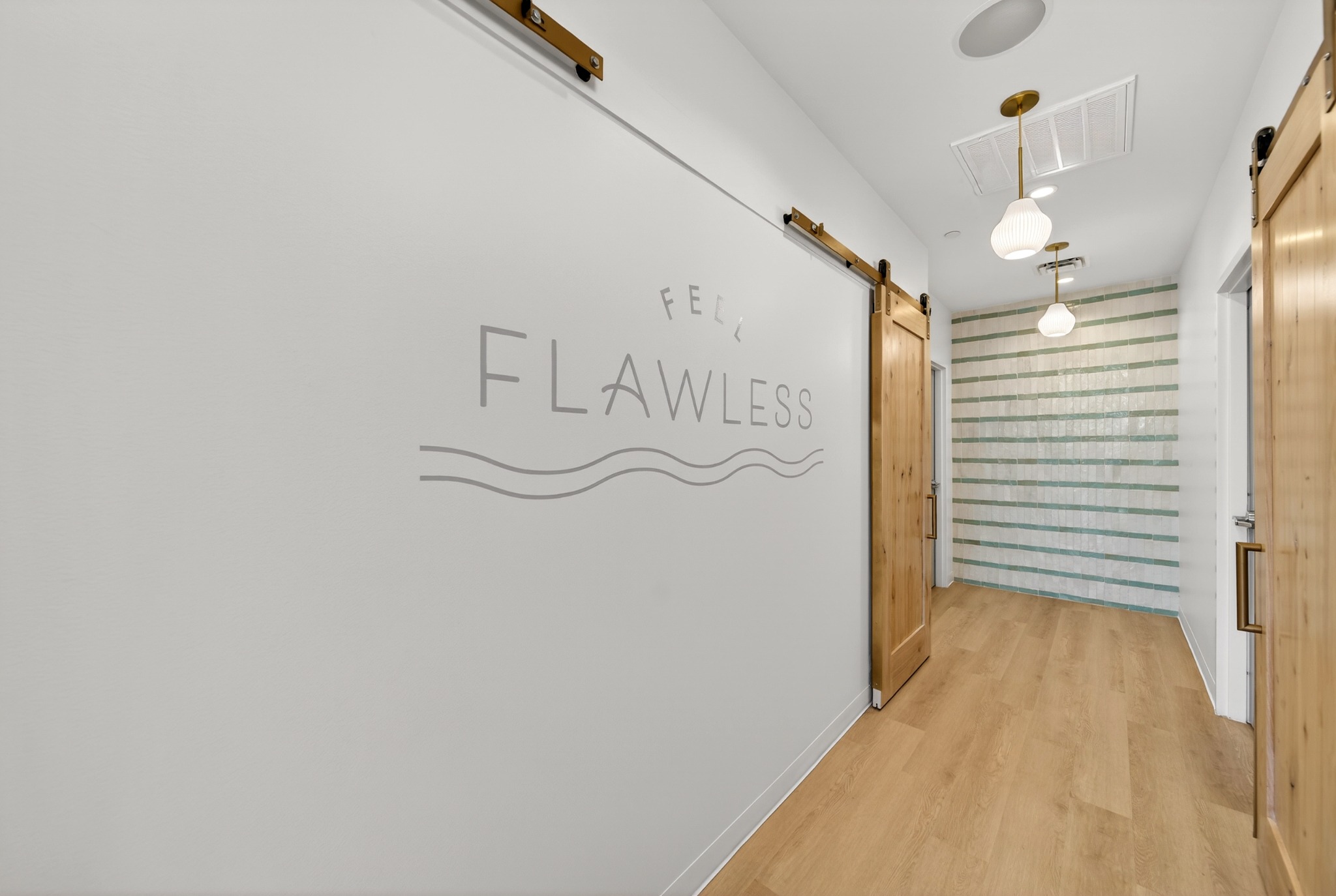 Flawless wall lettering beside a treatment room corridor
