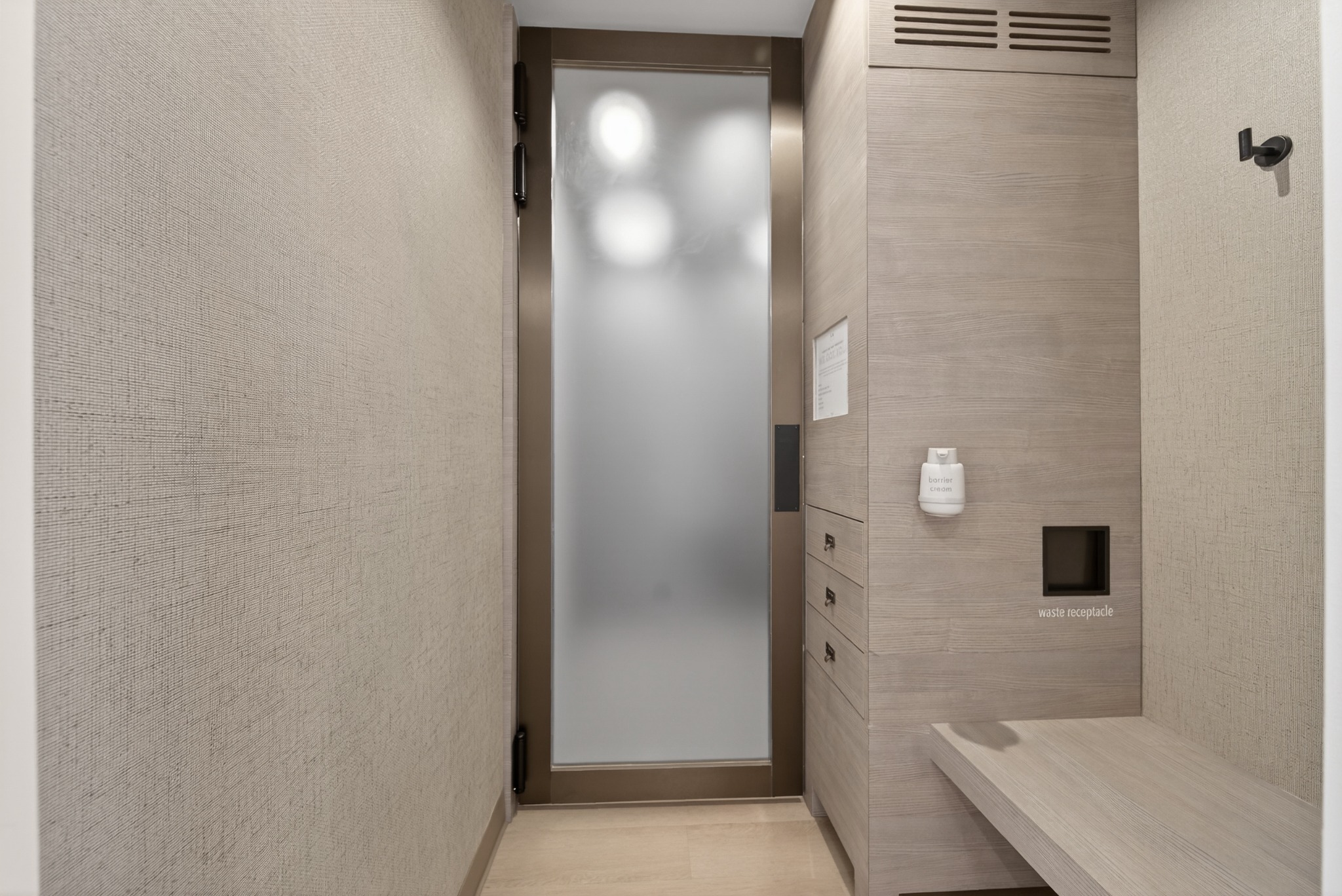 Shower area with textured walls and built in bench