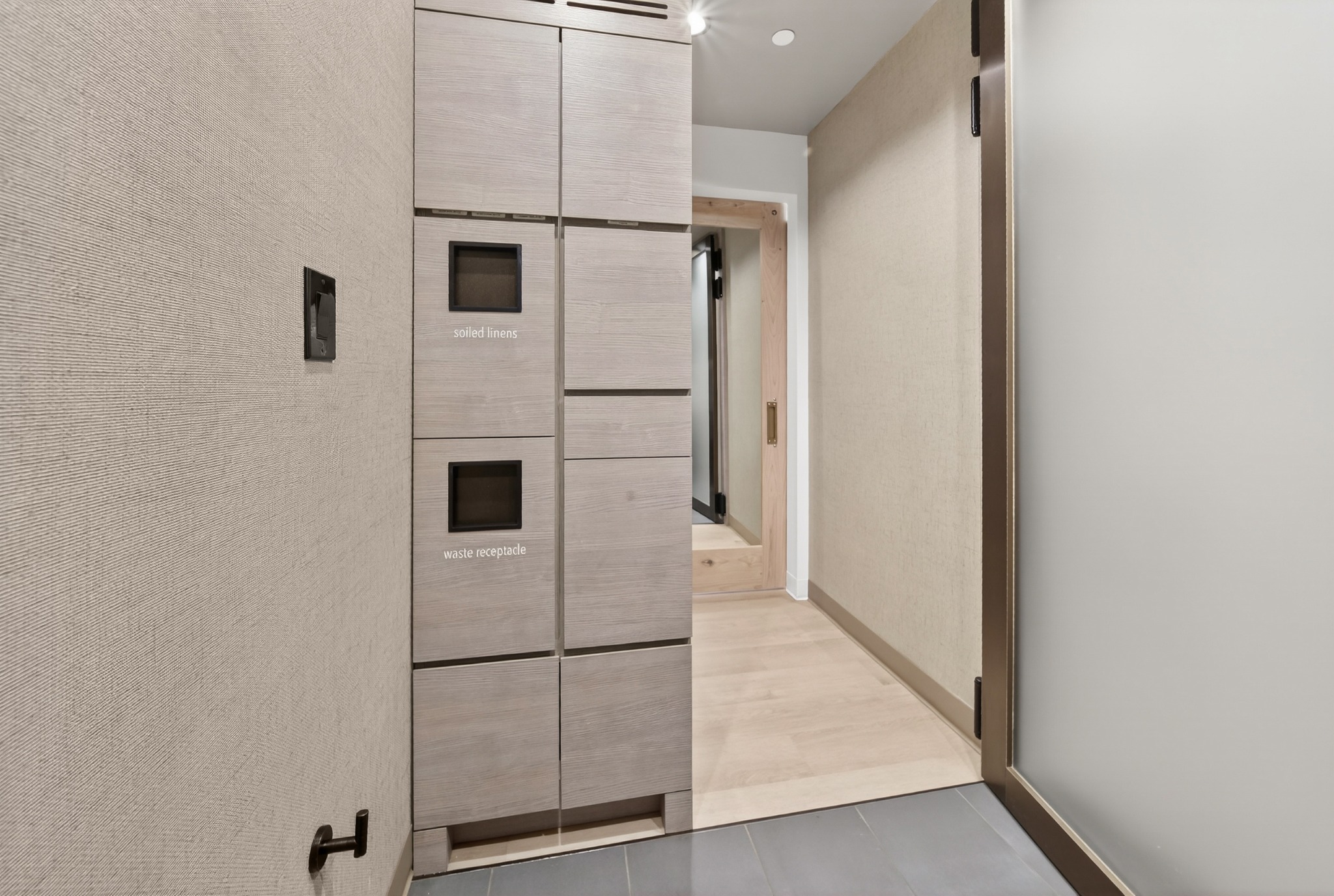 Changing area with storage cabinets and doorway